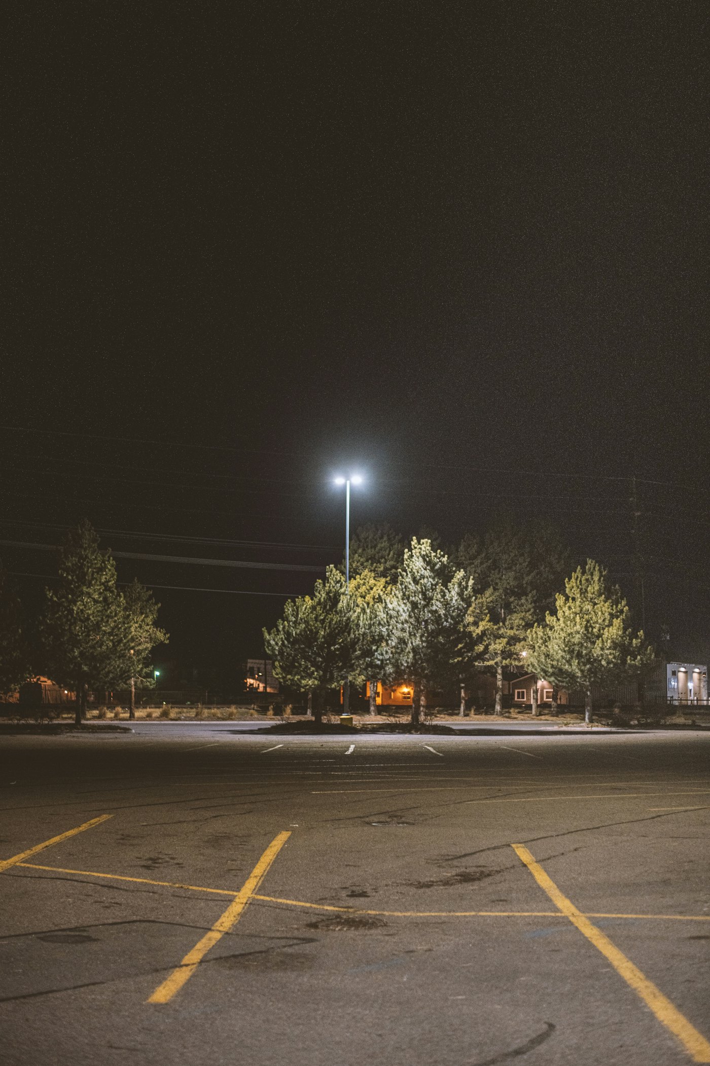 Parking lot light pole lit at night