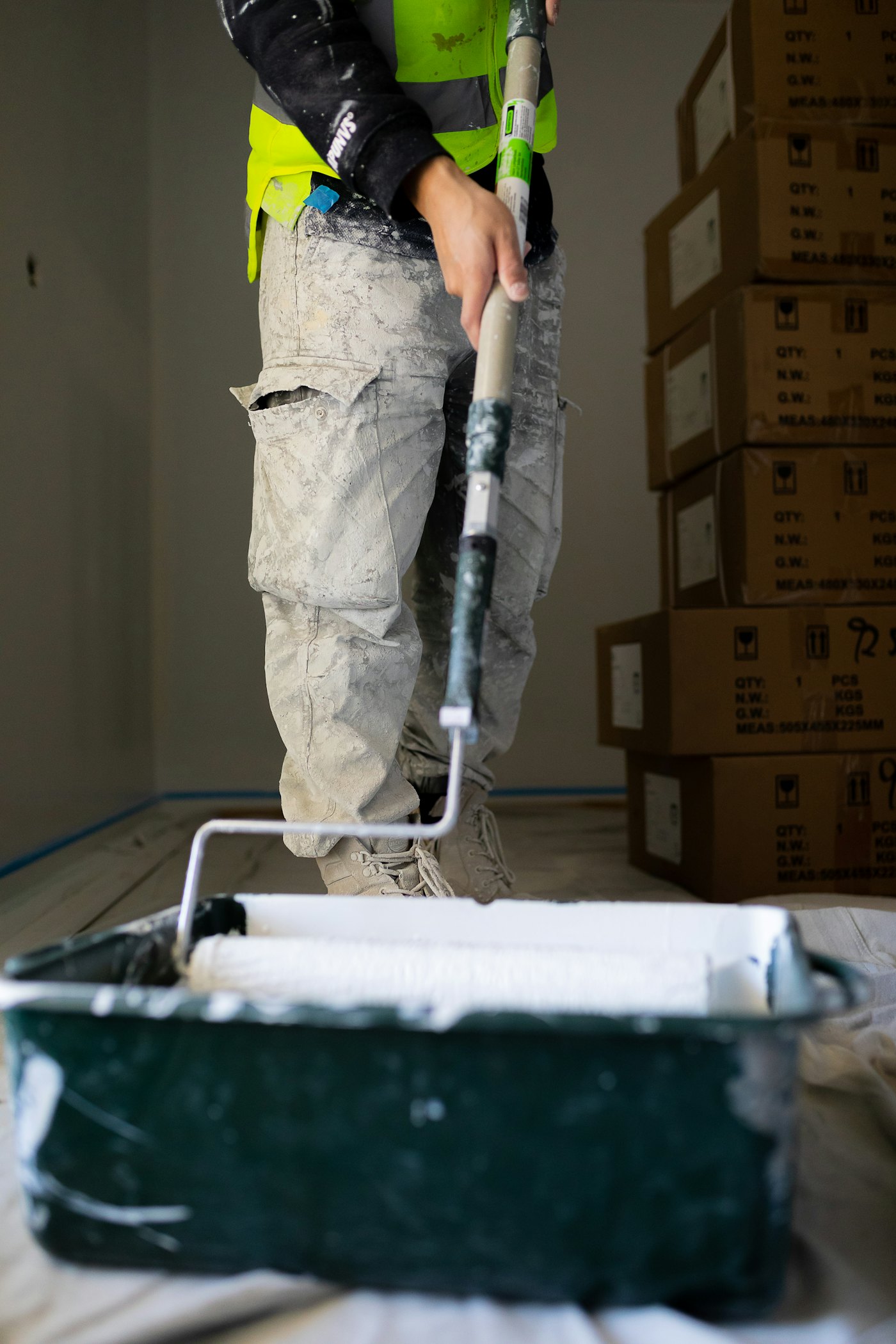Painter rolling a wall